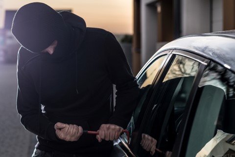 A criminal attempts to break into a car