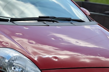 Hail damage wreaks havoc on a car bonnet